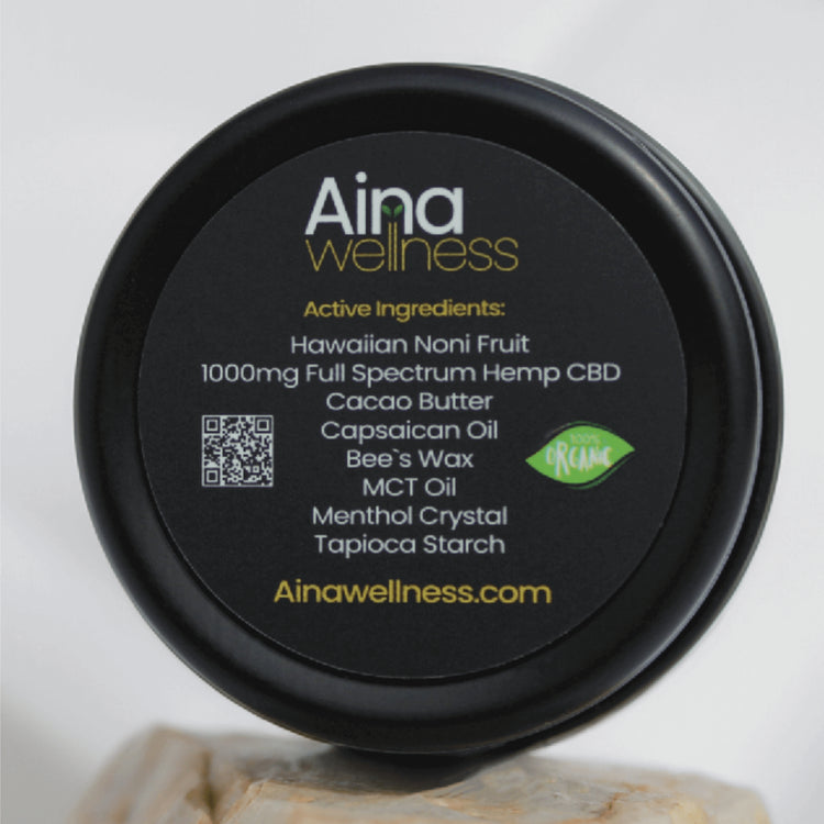 Aina Wellness Tropical CBD Topical Balm, showcasing its active ingredients, including Kauai-grown Noni fruit and premium CBD Hemp, blended for a icy cool soothing or a heat-activated sensation | CBD Direct Solutions