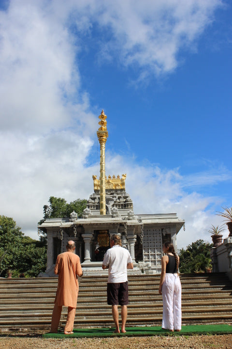 Acharya Arumuganathaswami, a senior monk in Kauai, standing in front of the Hindu Monastery, providing a vital role in the culture and synergy of botanicals for Aina Wellness Hemp products | CBD Direct Solutions